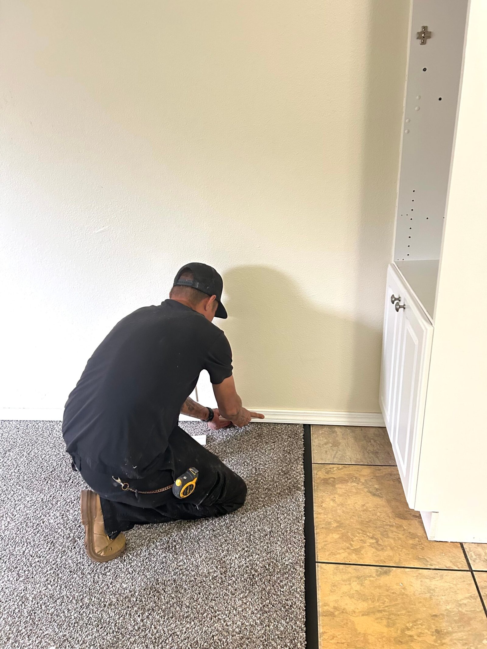 man fixing baseboards