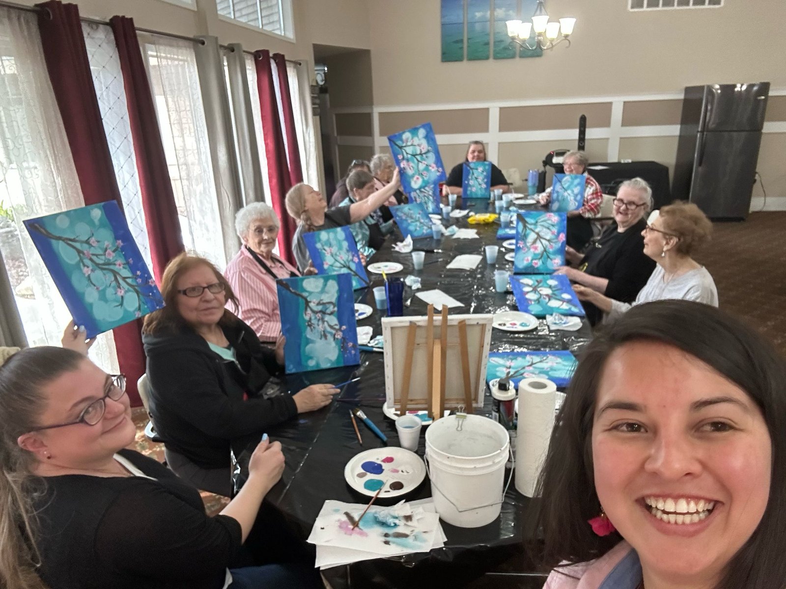 A group of older women showing their paints