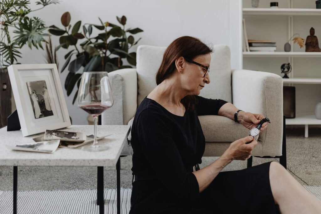 older woman siting alone on the floor in a black dress