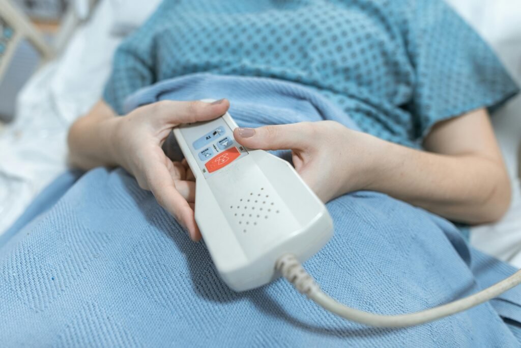 person holding a bed controller in a hospital bed