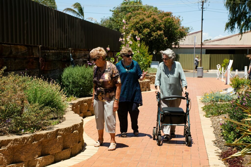 three older ladies walking and looking at the flowers