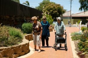 three older ladies walking and looking at the flowers