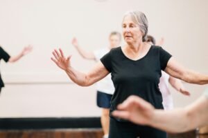 older woman in an exercise group class