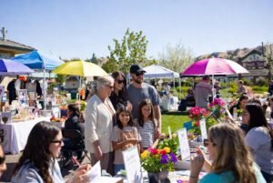 Multi-generational family having fun with DIY crafts, Garden on the Go planting, and shopping at the Pages & Petals Mother’s Day Bazaar at Peach Tree Retirement Center in Yakima — the best things to do on Mother’s Day in Yakima this weekend with only 7 days left